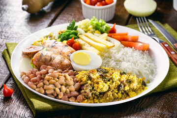 roasted and grilled sausage, smoked pork, served hot with rice and beans, farofa, tomato, salad and fries. Typical Minas Gerais food, Brazilian lunch