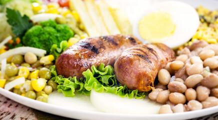 brazilian roasted and grilled sausage, smoked pork, served hot with salad and fries