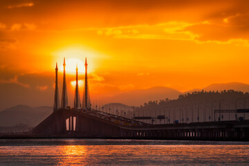 Sun on middle of bridge pole