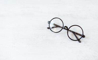 Fototapeta na wymiar Classic style glasses on white texture background, eyewear fashion, reading glasses