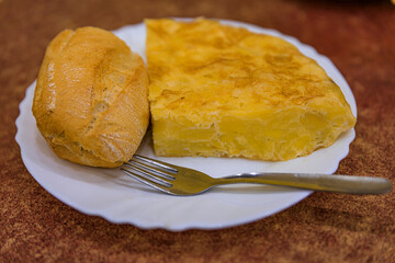Spanish potato tortilla served with bread in a restaurant in Madrid, Spain
