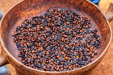 Roasted coffee beans in a rustic bowl
