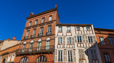 Facades of houses in Toulouse in Occitanie, France