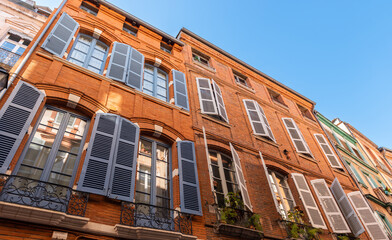 Facades of houses in Toulouse in Occitanie, France