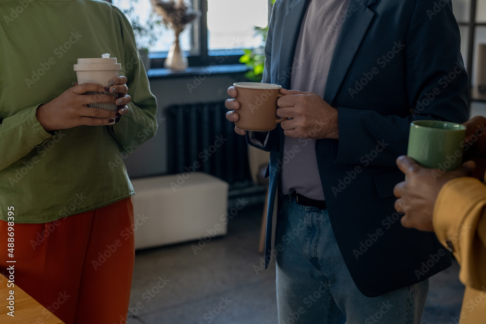 Aufkleber group of elegant male and female office workers in smart casualwear having drinks and talking at bre
