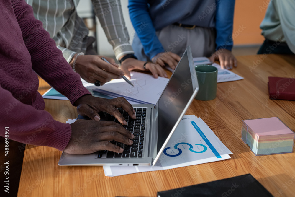Poster hands of african-american businessman typing on laptop keyboard while analyzing financial data again