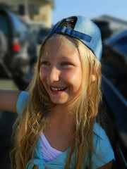 A girl in a denim cap with long hair