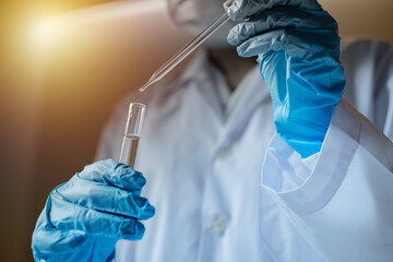 Life scientists researching in laboratory. Focused female life science professional pipetting...
