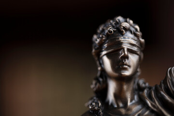 Fototapeta na wymiar Judge office. Justice symbol - Themis sculpture on brown background.