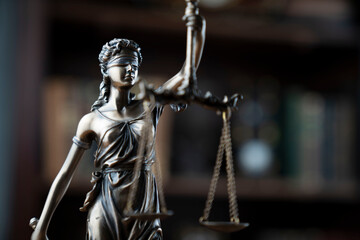 Fototapeta na wymiar Judge office. Justice symbol - Themis sculpture on brown background.