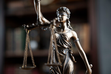 Judge office. Justice symbol - Themis sculpture on brown background.