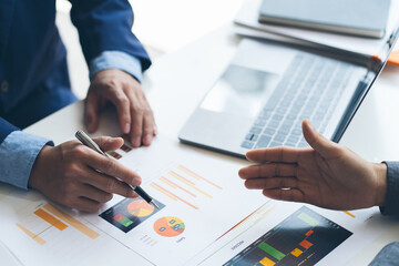 teamwork company meeting concept, business partners working with laptop computer together analysing startup financial project result or strategy plan and discussing data document in office