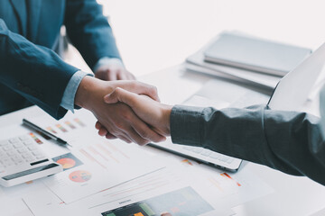 Finishing up a meeting, handshake of two happy business people after contract agreement to become a partner, collaborative teamwork.