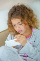 Young girl playing on electronic device