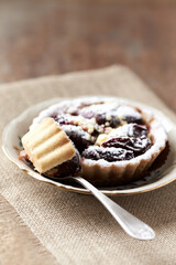 Plum pie on rustic stone background. Close up.