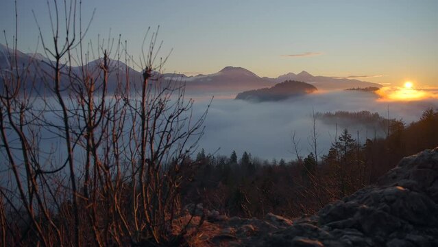 Bled Slovenia captured at sunrise with in the nature with beautiful mountains and landscapes cover in fog and nice golden hour colors filmed in  dynamic movement with a camera on a gimble