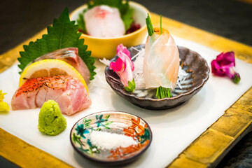 Fototapeta na wymiar a raw fish sashimi set presented on a china plate in a Japanese restaurant