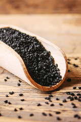 Black cumin essential oil in a small bottle. Selective focus.