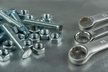 Tool for assembling threaded connections. Wrenches, nuts and bolts. Close-up on the background of a metal blank.