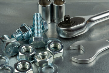 Tool for assembling threaded connections. Wrenches and heads. Close-up on the background of a metal blank.