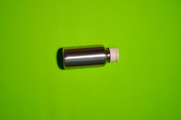 Reusable iron water bottle in a woman's hand. Steel water bottle to limit the use of plastic bottles