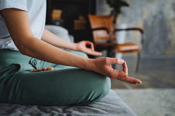 The side view of the hand in the meditation pose fingers folded into the rank of mudru. A young...