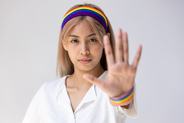 Modern LGBT woman showing stop hand gesture, concept of non-binary people acceptance, stop LGBT hate and misunderstandiing, rejecting discrimination against LGBT people or inclusivity and diversity