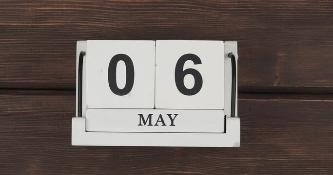May calendar, change of days. wood calendar with date month and day on a wooden table. fast pace of time during the month. accelerated calendar. Stop motion. 