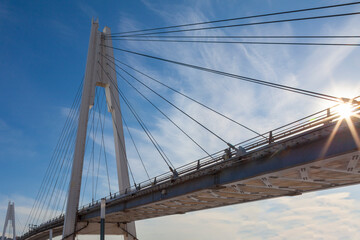 Fototapeta na wymiar Picturesque footbridge against a blue sky in light clouds