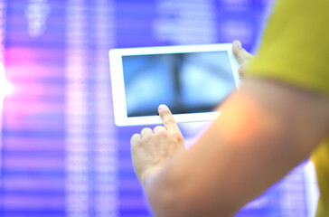 Man makes check-in with touchpad at airport.
