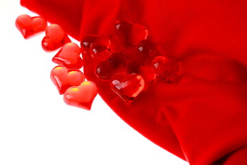 Shapes of colored hearts on a red background.