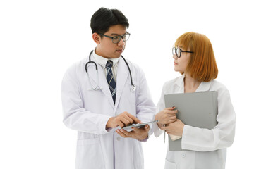 Fototapeta premium Isolated cutout studio shot of Asian young professional male doctor in lab coat with stethoscope and eyeglasses standing holding tablet discussing patient data with female intern on white background