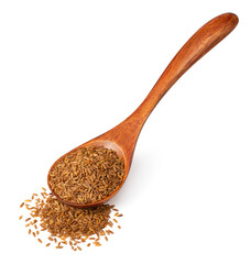 Roasted cumin seeds in the wooden spoon, isolated on the white background.