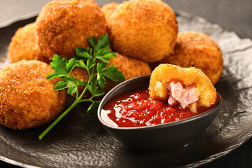 POTATO CROQUETTES with ham and sauce close-up
