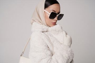 Beautiful young lady in a white faux fur coat - 488708574