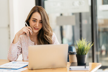 Portrait of smiling beautiful business asian woman working in office use computer with copy space. Business owner people sme freelance online marketing e-commerce telemarketing, work from home concept