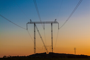 high voltage towers in the sunset - 488709146