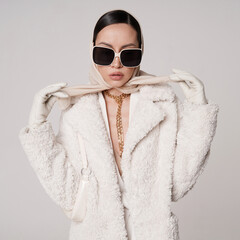 Beautiful young lady in a white faux fur coat - 488709177