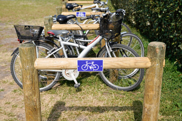 parking of bicycles wooden sign of a bicycle parked in park forest background - Powered by Adobe