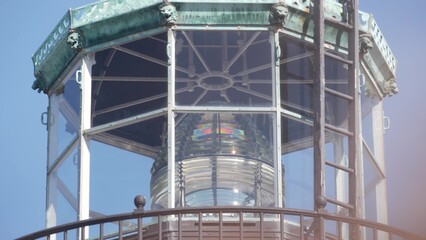 Vintage lighthouse tower, retro light house, old fashioned historic classic beacon, fresnel lens. Nautical navigational coastal building 1855. San Diego, California USA. Seamless looped cinemagraph.