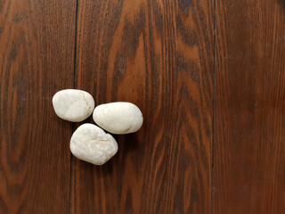 white pebbles on wooden background