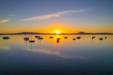 Aerial sunrise waterscape with boats