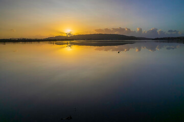 Hazy Sunrise Waterscape with Reflections