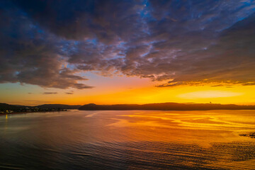 Fototapeta premium Aerial sunrise seascape with low clouds