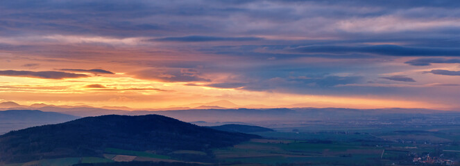 Sunset with dramatic cloudy sky over mountains shape, beautiful nature landscape
