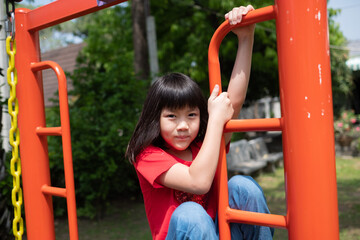 Fototapeta na wymiar Children playing at the playground, happy girl