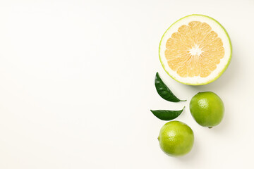 Sweetie, limes and leaves on white background