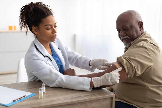 Senior Man Getting Vaccinated Against Covid, Doctor Applying Plaster