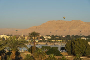 Hot air balloons over Luxor city and Nile river in a beautiful morning sunrise, Upper Egypt