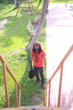 long haired hippie with guitar